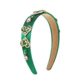 Detailed shot of emerald green baroque headband with heart-shaped rhinestones and gems - Green