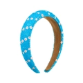 Blue padded headband with white floral pattern and textured beaded finish on white background - Blue