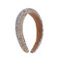 Detailed macro view of sparkling silver rhinestones and gold chain on the padded headband - Silver