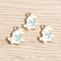 Three white enamel bunny charms with blue hearts on a natural wood surface for DIY jewelry - 10 Pieces Pack / Blue
