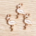 Close-up of golden enamel flamingo charms with intricate metal finish for DIY jewelry - 10 Pieces Pack / White