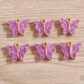 Detailed view of six purple glitter butterfly pendants with gold outlines for DIY jewelry - 10 Pieces Pack / Purple