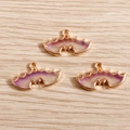 Detailed macro view of three purple gradient bat wing charms with gold metal frames - Purple