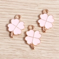 Close-up of pink enamel four-leaf clover charms with rose gold metal edges for DIY jewelry - Pink