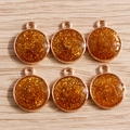 Detail of round gold glitter resin pendants with metal loops for DIY jewelry making - 10 Pieces Pack / Orange