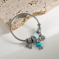 Silver twist cable charm bracelet with blue glass beads and sparkling heart pendant - Blue