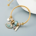 Bracciale rigido dorato con ciondolo occhio di Allah in cristallo e dettagli turchesi - Oro/Azzurro