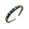 Close-up of Baroque headband with emerald green crystals and rhinestones in gold setting - Green