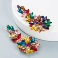 Detail of colorful crystal hollow flower earrings with gold finish on jewelry display stands - Colorful