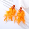 Detail of vibrant orange feather drop earrings with sparkling rhinestones and teardrop stones - Orange