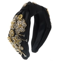 Close-up of gold and silver hand-sewn beadwork on a black knotted fabric headband - Black