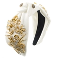 Close-up of handmade white fabric headband featuring intricate gold and silver floral beadwork - White