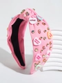 Detail view of pink knotted headband featuring colorful heart charms and beads - Pink