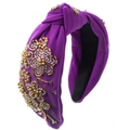 Close-up of deep purple knotted headband with intricate gold and silver bead embroidery - Purple