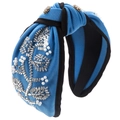 Detail of blue knitted headband with hand-sewn pearl floral patterns and top knot style - Blue