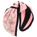 Detail view of pearl flower embroidery and gold rhinestone buttons on knot headband - Pink