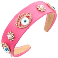 Close-up of pink padded headband with evil eye charms, pearls and rhinestones decoration - Rose Red