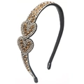 Detail view of double heart rhinestones on a slim black metal headband accessory - Brown