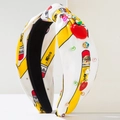 Close-up of school themed knot headband with yellow pencils, red apple, and Lucky badge - Yellow