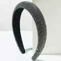 Close-up of thick sponge headband featuring dark grey rhinestones and black velvet lining - Gray
