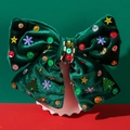 Nœud de Noël en velours vert avec paillettes et flocons de neige sur un support festif - Vert