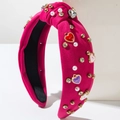 Detail of rose red headband featuring pearls, rhinestones and heart charms with Love text - Rose Red