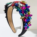 Macro detail of ornate wide headband featuring multi-colored gemstones and baroque style - Colorful
