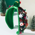 Close-up of festive plaid headband with 3D Santa decor and green knit ball detail - Green Big Snowflake