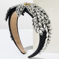 Luxury floral rhinestone headband with crystal petals on black velvet base displayed on white - White