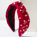 Cerchietto rosso con nodo, perle bianche e ciondoli LOVE dorati su supporto - Rosso