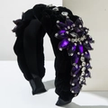 Velvet braided headband with purple gemstones and crystals on a white pedestal - Purple