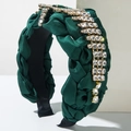 Detailed texture of dark green hand-woven satin headband with emerald gemstones and crystals - Green