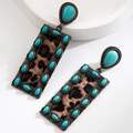 Detail view of retro bronze earrings with leopard texture and turquoise gemstone inlay - Rectangular Brown Leopard Style