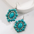 Bohemian floral turquoise earrings with colorful rhinestones on a white display - Oval-Green