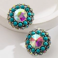 Macro detail of retro bohemian stud earrings featuring iridescent crystal and turquoise beads - Blue