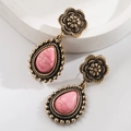 Detail view of vintage gold teardrop earrings with pink textured marble stones - Waterdrop Floral Style / Antique Gold