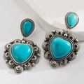 Detail of bohemian turquoise drop earrings featuring vintage silver engraving and heart stones - Turquoise Heart