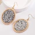 Elegant gold oval earrings with silver sequins and pearl border on white stone stand - Silver Glitter (5958725953591) / Silver