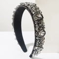 Close-up of luxury Baroque headband with hand-sewn crystals and rhinestones on black fabric - Gray