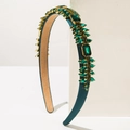 Close-up of vintage emerald green crystal headband with gold metal claw settings - Green