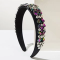 Close-up of wide velvet headband with colorful rhinestones and imitation pearls - Colorful