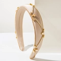Close-up of champagne gold baroque headband with rhinestones and satin finish - Beige