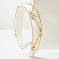 Detailed close-up of white satin headband with gold chains and inlaid clear crystals - White