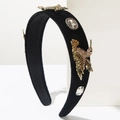 Detail of vintage baroque velvet headband featuring 3D golden birds and crystal accents - Brown