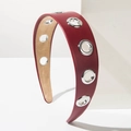 Dark red PU leather headband with silver metal eyelets in a trendy punk style finish - Red