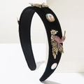 Detailed close-up of velvet headband featuring golden birds and colorful rhinestone accents - Pink