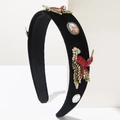 Detail of vintage Baroque headband with velvet texture and crystal hummingbird ornaments - Red