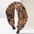 Macro detail of wide twisted knot headband with vintage brown paisley print fabric - Iridescent Black