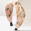 Close-up of pink paisley fabric headband with top knot and soft floral patterns - Pink Multi