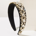 Detailed close-up of a wide black headband embellished with sparkling crystal rhinestones - White